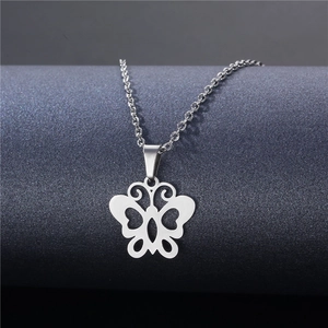 Polished stainless steel butterfly pendant necklace on a minimalist dark display stand
