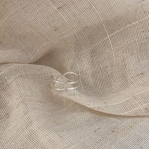 S925 sterling silver double-layered open ring with minimalist woven design on linen texture
