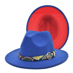 Detail of royal blue fedora hat with red brim lining and colorful snakeskin band
