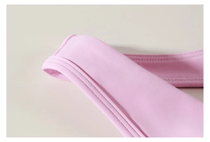 Détail de la bandoulière de brassière de sport rose avec couture double aiguille
