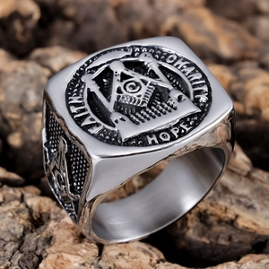 Macro detail of silver Masonic ring featuring Faith, Hope, Charity engravings and textures