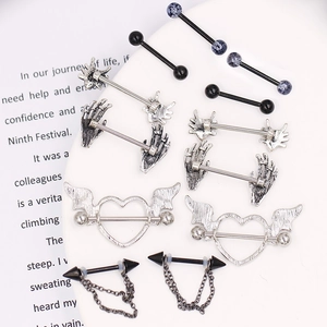 Close-up of assorted goth nipple rings including skeleton hand and bat wing designs