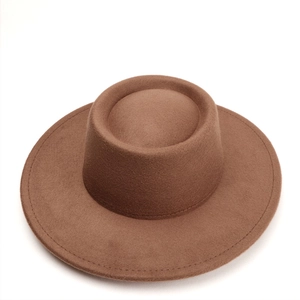 Close-up of a brown wool felt pork pie hat featuring a wide brim and detailed stitching