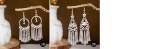 Detailed close-up of ethnic silver tassel earrings with hollow leaf and peacock patterns