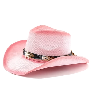 Detail of pink straw cowboy hat with bohemian ribbon, seashell and starfish accents