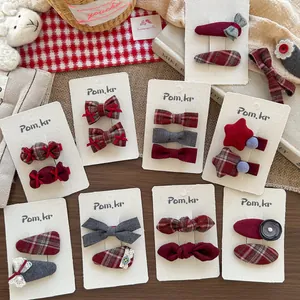 Detail of Korean style red and grey fabric hair clips set with bows and heart patterns