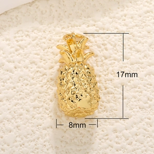 Macro shot of gold pineapple pendant with detailed texture and 17mm x 8mm dimensions