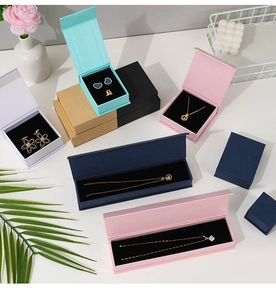 Overhead view of various colorful jewelry gift boxes with elegant floral decorations