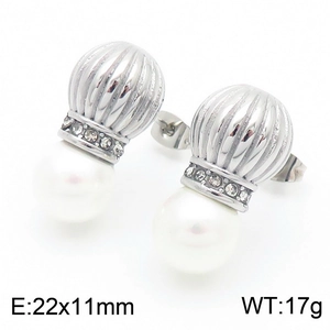 Detailed view of silver threaded stud earrings with small diamonds and white pearls