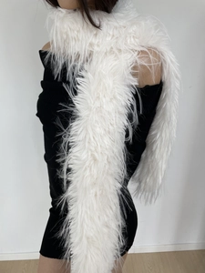Detail showing the fluffy texture and soft white faux fur of this long plush winter scarf
