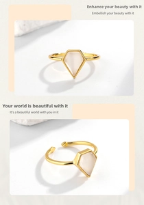Detailed close-up of a minimalist gold-plated open ring with a white kite-shaped stone