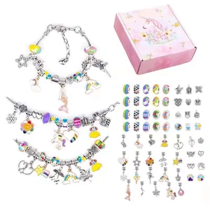 Detail of DIY ocean-themed charm bracelet kit with silver chains and unicorn gift box