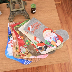 Detailed top view of five festive linen Christmas stockings with Santa and reindeer motifs
