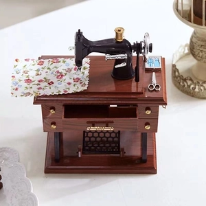 Retro miniature sewing machine music box with wooden finish and mechanical moving parts