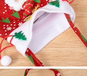 Detail of Christmas Santa gift bag featuring red burlap texture and fuzzy plush trim