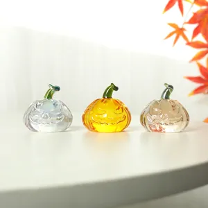 Three crystal pumpkin decorations for Halloween with colorful finishes and maple leaf accents