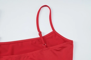 Detail of adjustable metal buckle and thin shoulder strap on red bodycon dress set
