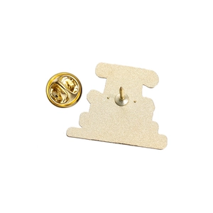 Detail of the golden metal pin back and butterfly clutch closure for accessories