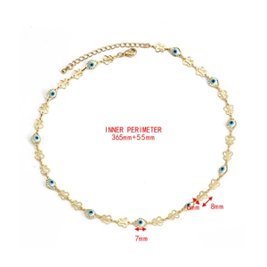 Detail view of Evil Eye necklace featuring gold butterfly links and blue enamel beads