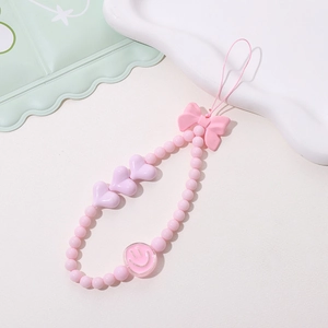 Detail der rosa Handy-Perlenkette mit Schleife, lila Herzen und Smiley-Perle