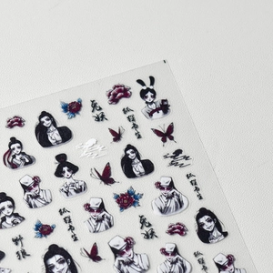 Detailed macro view of dark Japanese style nail stickers featuring fox and rabbit spirits