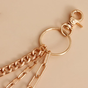 Detail of gold multi-layer metal pants chain with hollow heart and lobster clasp