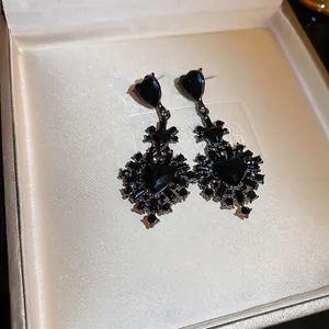 Gothic black heart earrings with crystal drops in a beige luxury jewelry gift box