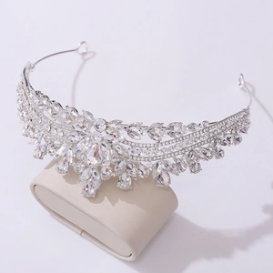 Elegant silver bridal crown with shimmering rhinestones on a display stand