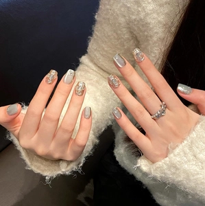 Detailed view of cat-eye press-on nails with luxury pearls and gold diamond accents