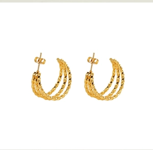 Detailed view of 18k gold plated stainless steel hoop earrings with triple twisted rope design