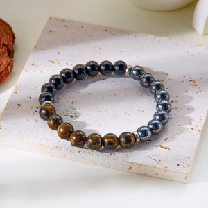 Macro shot of 8mm natural tiger eye beads and black hematite on stone display