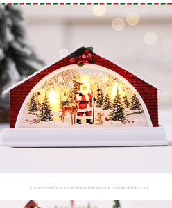 Close-up of a festive Christmas snow globe house with Santa, reindeer and warm LED lights