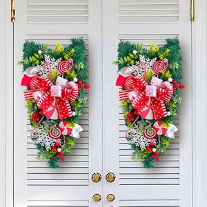 Christmas upside down tree decoration with candy cane and red bow on white shutters