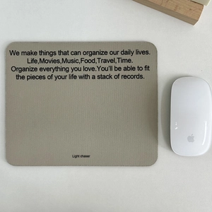 Minimalist grey non-slip desk mat with inspirational text and wireless mouse