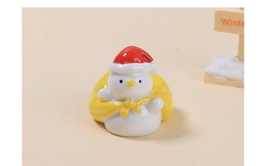 Close-up of a snowman figurine in a yellow bag for DIY crafts and decorations