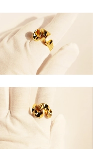 Detailed view of the wavy irregular fluid shape gold ring with metallic texture
