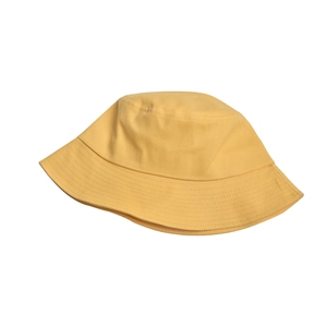 Detail of bright yellow cotton fisherman hat showing texture and stitching on white background