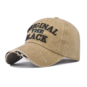 Detail of distressed khaki cotton baseball cap with The Black embroidery and frayed brim