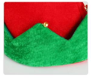 Detail of red and green Christmas elf hat with golden bells and jagged felt brim