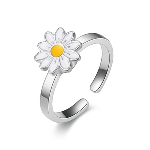 Primer plano detallado de un anillo plateado ajustable con dije de margarita blanca
