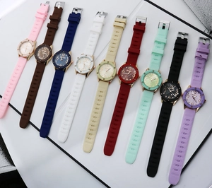 Flat lay of retro quartz watches in ten colorful silicone straps with golden cases