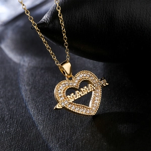 18K gold plated heart necklace with zircon inlay and MAMA lettering on black background