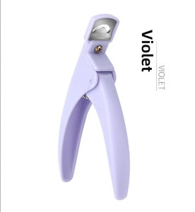 Detail of purple nail tip cutter with ergonomic plastic handle and sharp metal blade