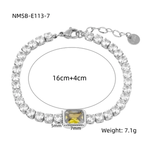 Macro detail of silver tennis bracelet with yellow emerald-cut stone and specs
