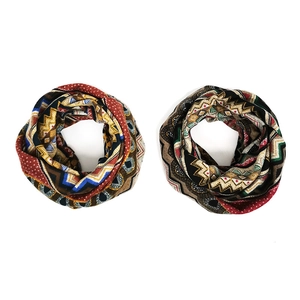 Detailed close-up of ethnic geometric pattern scarves in warm brown and teal tones