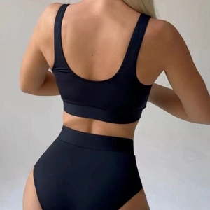 Women's black two-piece bikini set with sporty high-waisted cut and racerback design