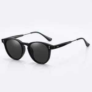 Classic polarized black round frame sunglasses with vintage metal temples on white background