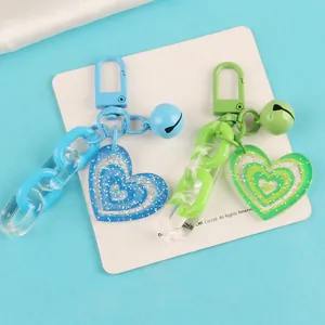 Creative heart charm keychains with colorful acrylic chains and bells in blue and green