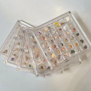 Stack of clear acrylic display boxes with magnetic lids for shell and starfish specimens
