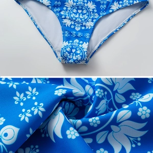 Macro detail of royal blue swimsuit bottom with white ethnic floral and dove print patterns